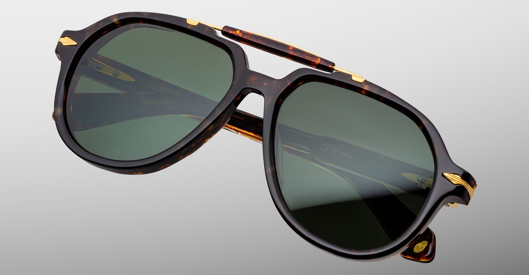 Jacques Marie Mage 1991 tortoiseshell sunglasses with green lenses and gold accents, shown from the front.