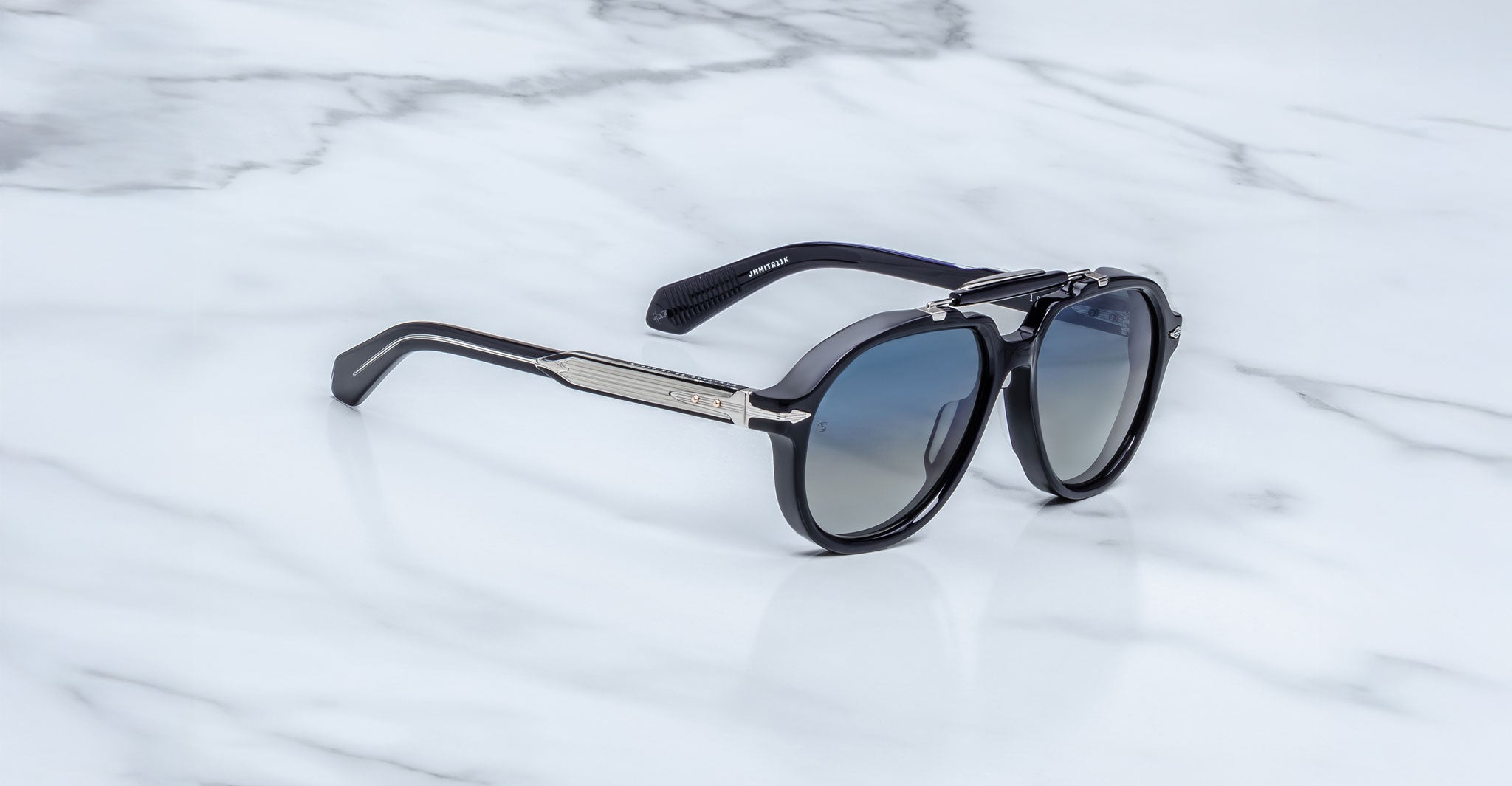 Jacques Marie Mage 1991 polarized sunglasses, black and silver frame with dark lenses, shown from above.