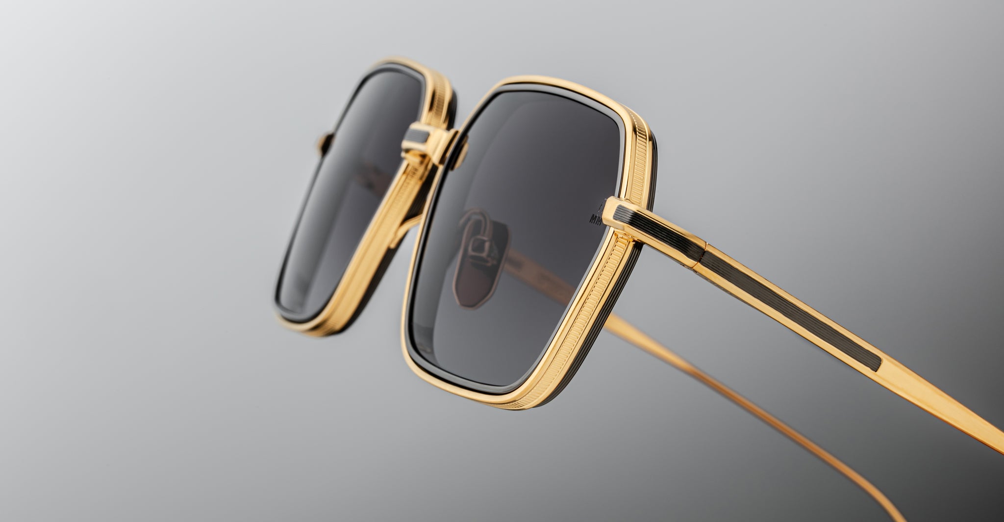 Jacques Marie Mage Admiral gold-framed square sunglasses with dark lenses, displayed at an angle.