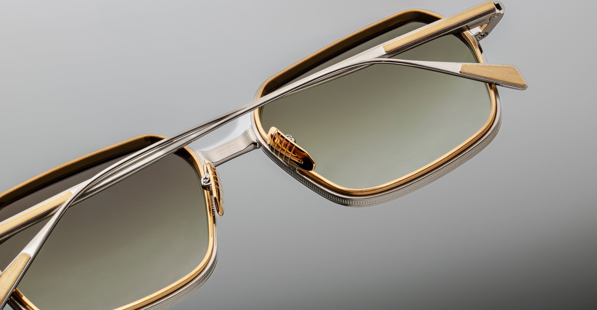 Angled close-up of Jacques Marie Mage Admiral rectangular gold-rimmed sunglasses with gradient lenses.