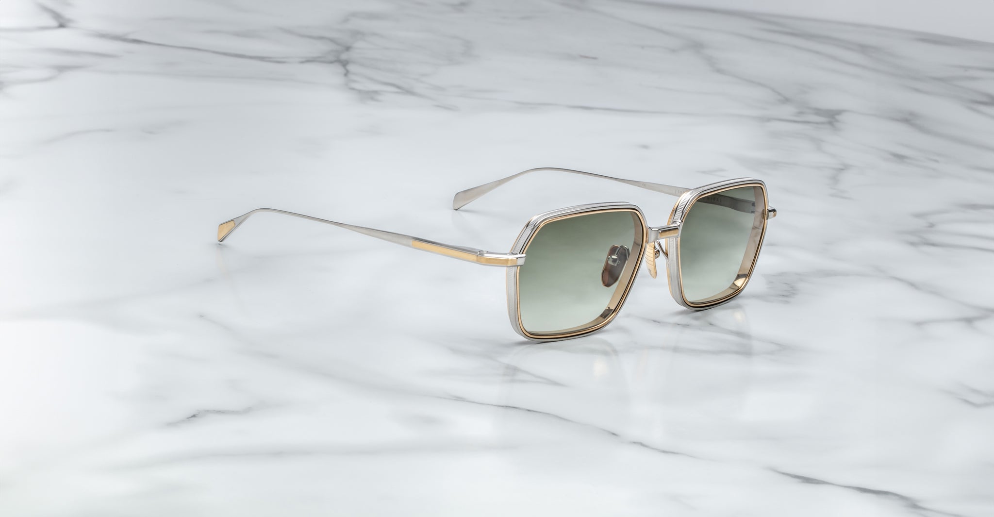 Jacques Marie Mage Admiral sunglasses with gold metal frames and green lenses, front view.