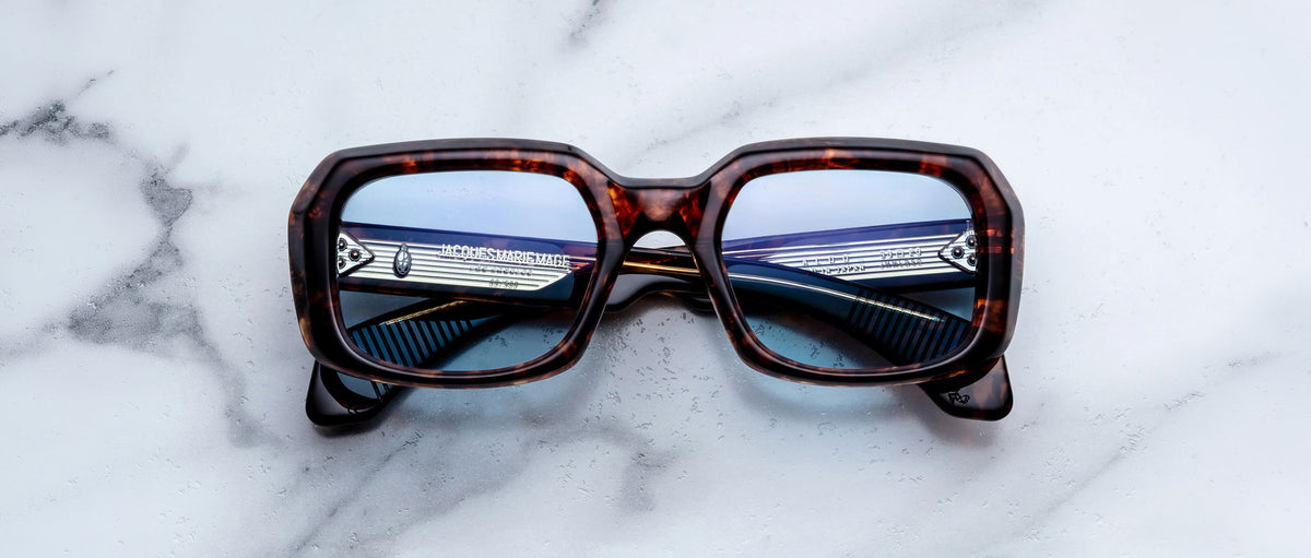 Jacques Marie Mage Aldo sunglasses, tortoiseshell square frame with blue lenses, shown from the front.