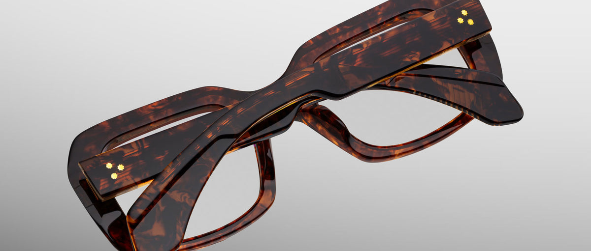 Jacques Marie Mage Aldo eyeglasses, thick rectangular brown tortoiseshell frames, folded, top view.