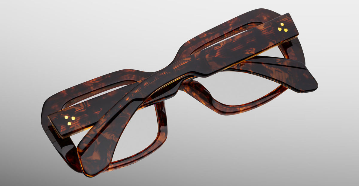 Jacques Marie Mage Aldo eyeglasses, thick rectangular brown tortoiseshell frames, folded, top view.