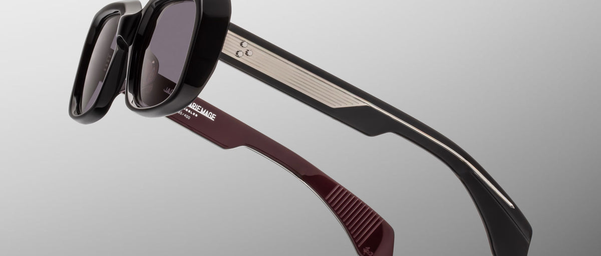 Jacques Marie Mage Aldo sunglasses with thick black frames and gradient burgundy temples, shown from the front.