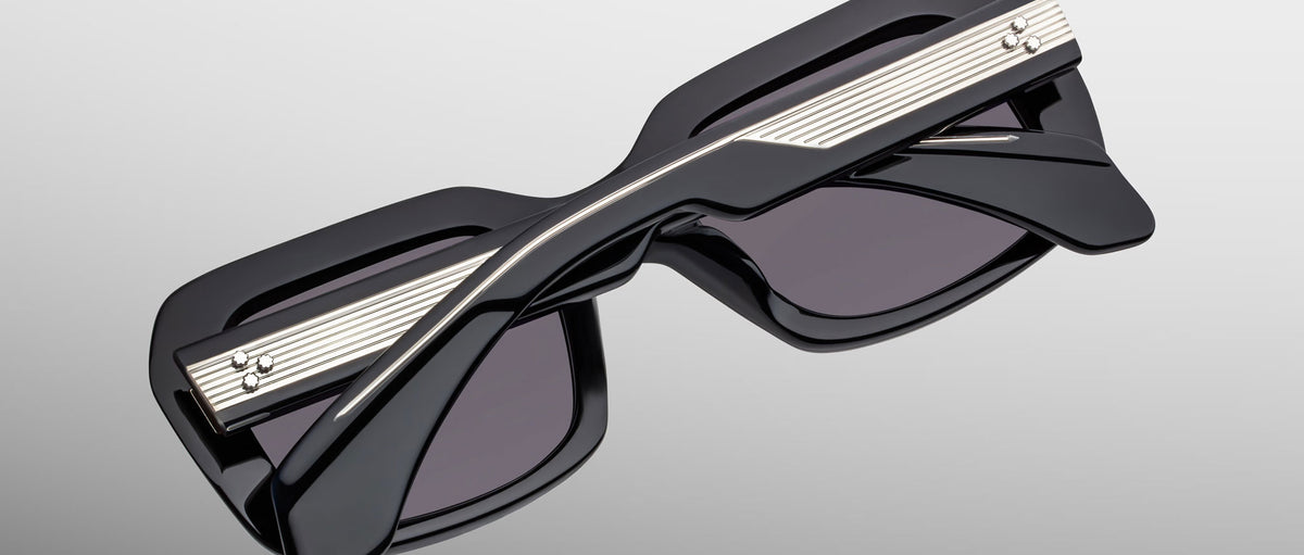Jacques Marie Mage Aldo sunglasses, black thick rectangular frames with silver accents, front view.