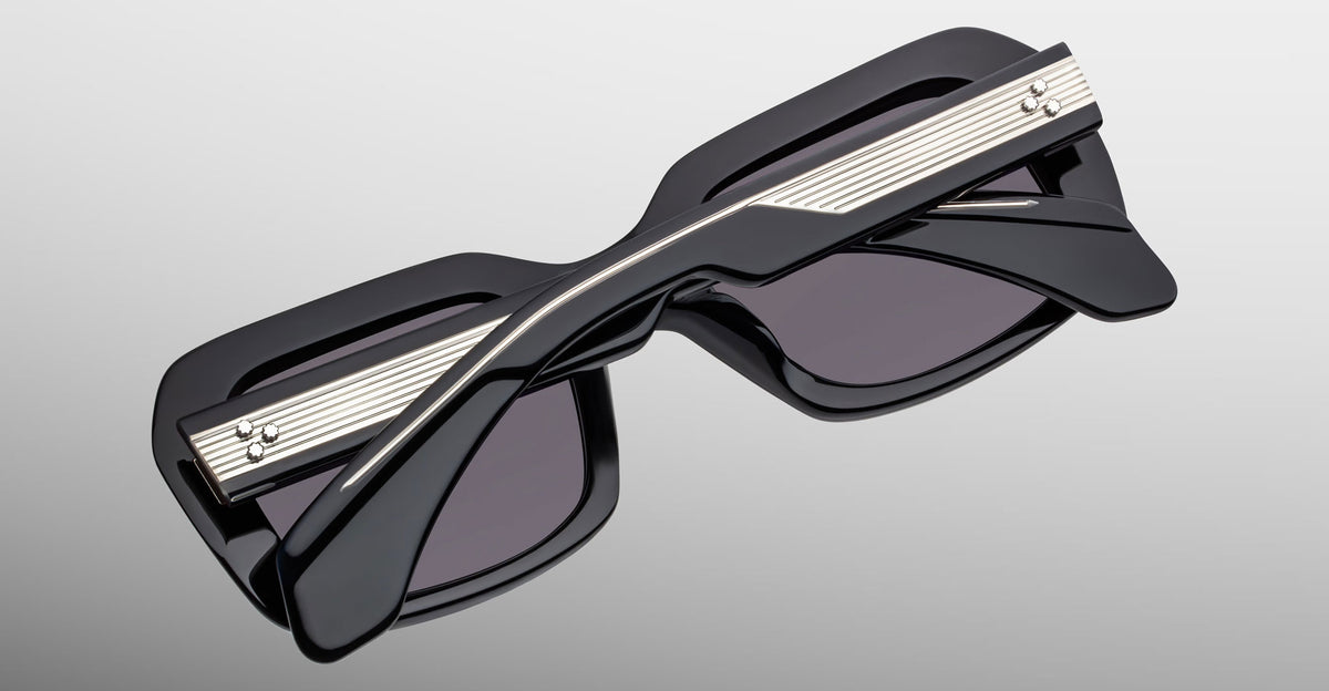 Jacques Marie Mage Aldo sunglasses, black thick rectangular frames with silver accents, front view.