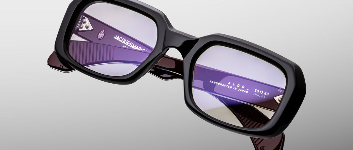 Jacques Marie Mage Aldo sunglasses, black rectangular frames, purple lenses, signature branded temples, front angle view.