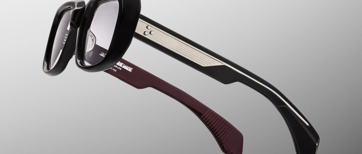 Jacques Marie Mage Aldo eyeglasses, black frames with silver trim, maroon inner temples, front view.
