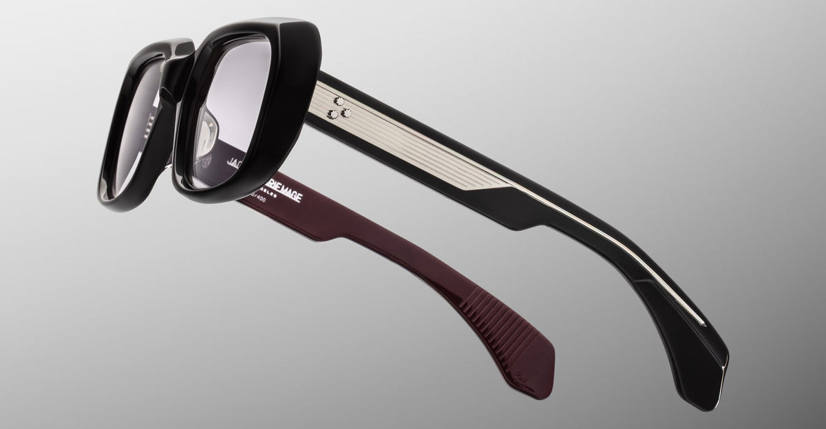 Jacques Marie Mage Aldo eyeglasses, black frames with silver trim, maroon inner temples, front view.