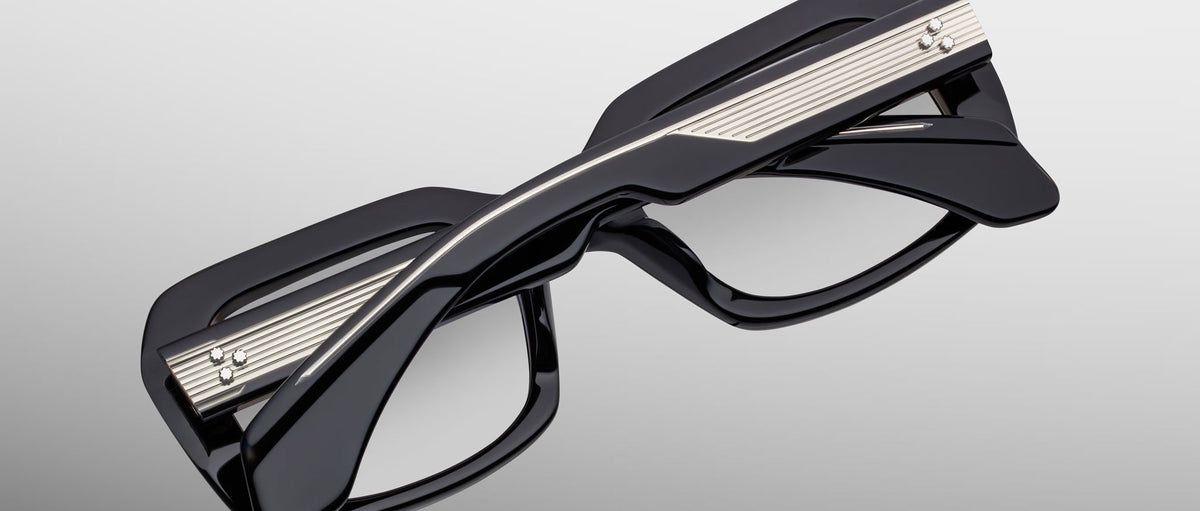 Jacques Marie Mage Aldo eyeglasses, black thick rectangular frames, twisted bridge, metallic temple accents, front view.