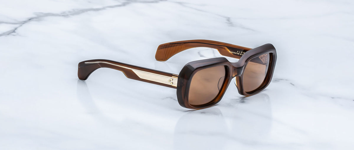 Jacques Marie Mage Aldo brown square sunglasses with UV lenses and gold accents, top view.