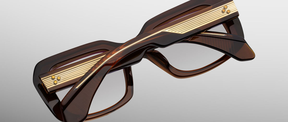 Jacques Marie Mage Aldo eyeglasses, thick brown rectangular frames with gold accents and bold temples, top view.