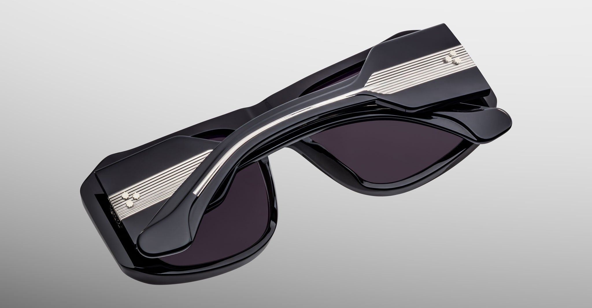 Jacques Marie Mage Alfie black polarized sunglasses with silver arms, side view showing frame and temple details.