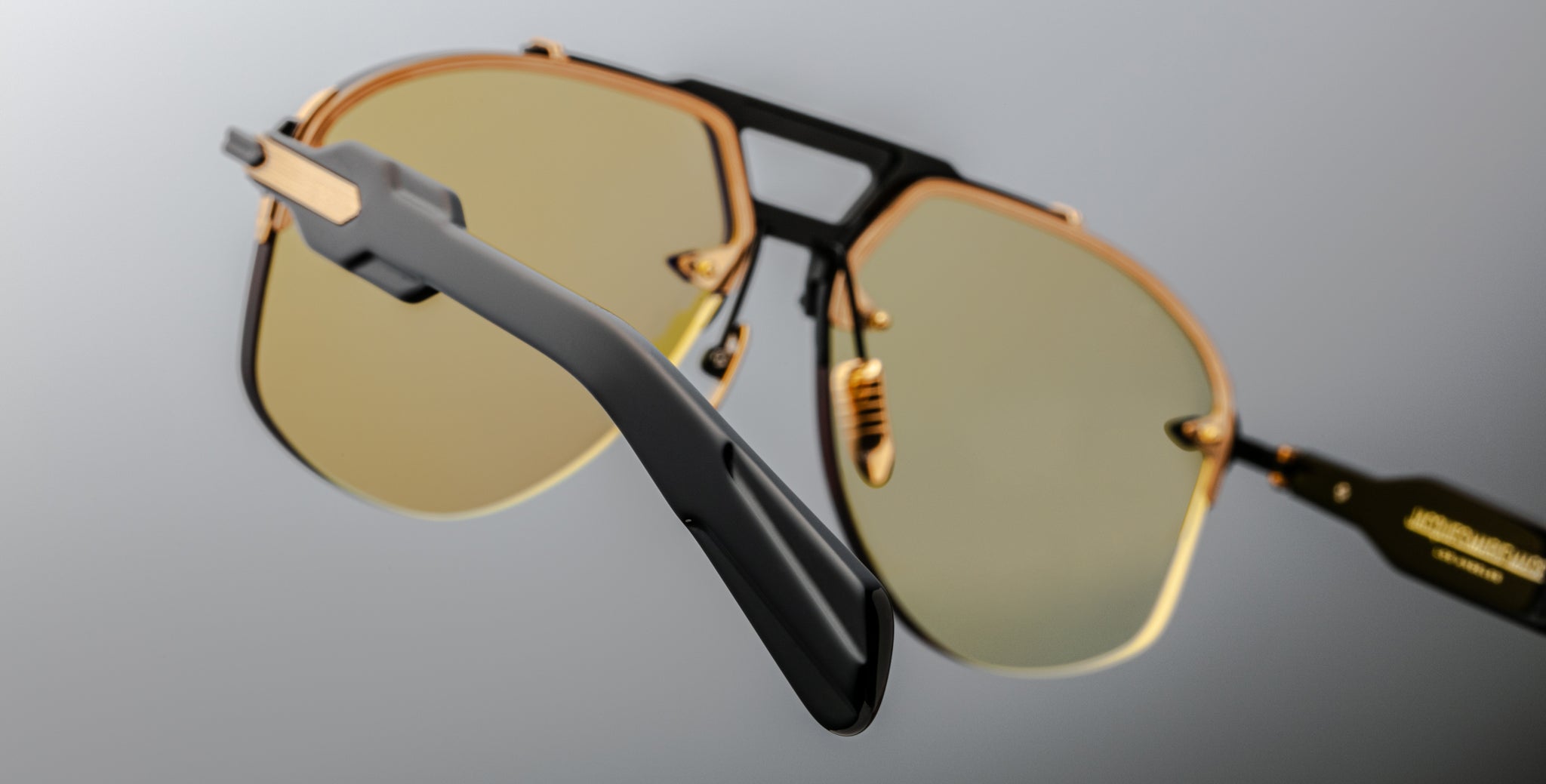 Jacques Marie Mage Alta sunglasses, gold rims, yellow lenses, black arms; close-up shows details of frame and lens color.