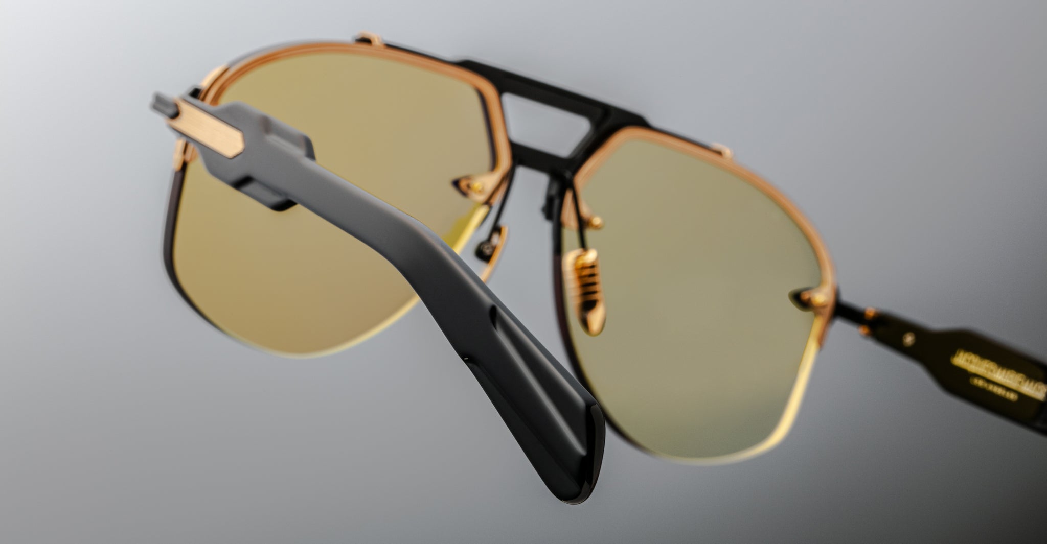 Jacques Marie Mage Alta sunglasses, gold rims, yellow lenses, black arms; close-up shows details of frame and lens color.
