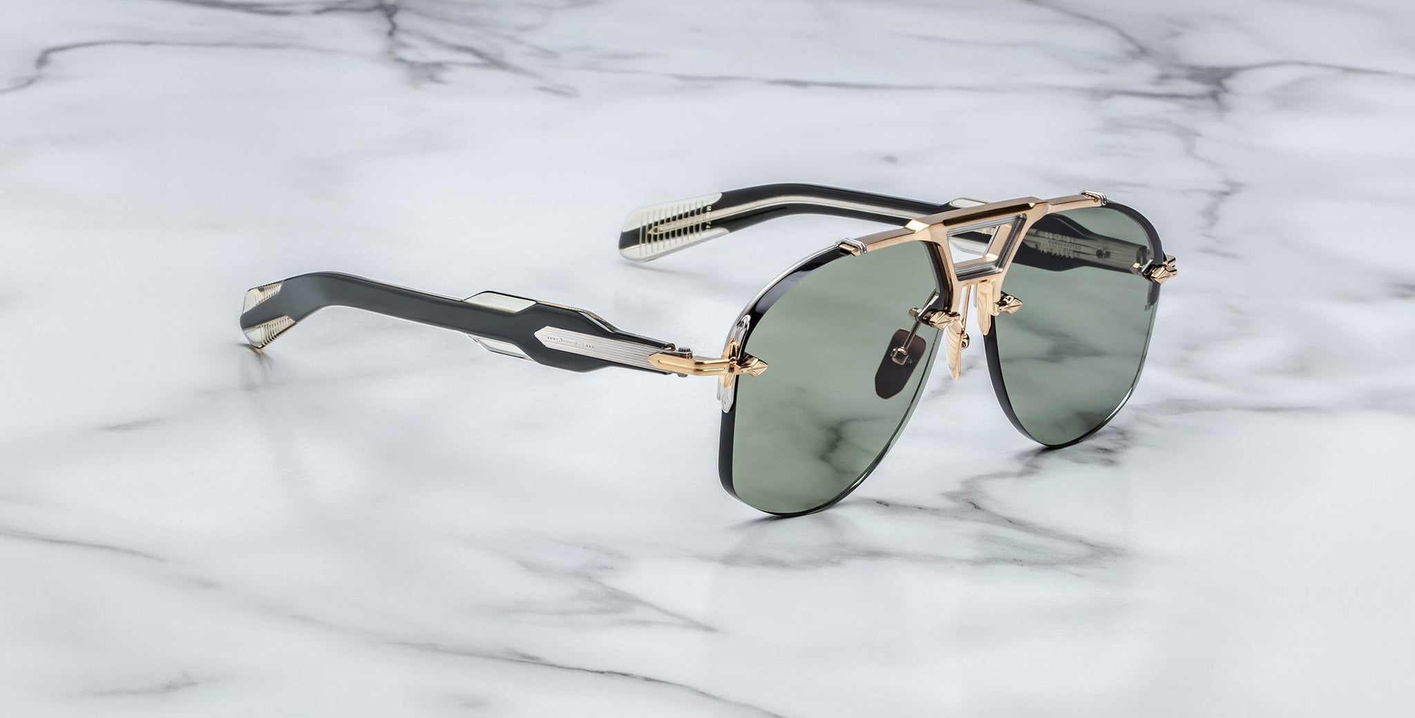 Jacques Marie Mage Alta aviator sunglasses with dark lenses and gold accents shown from above.