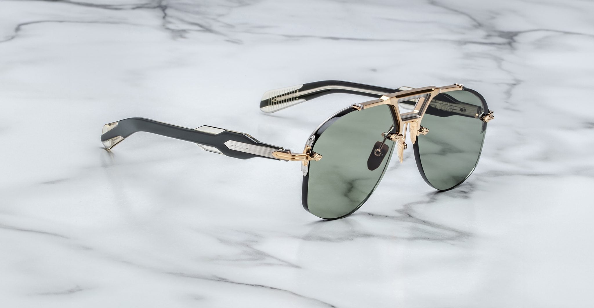 Jacques Marie Mage Alta aviator sunglasses with dark lenses and gold accents shown from above.