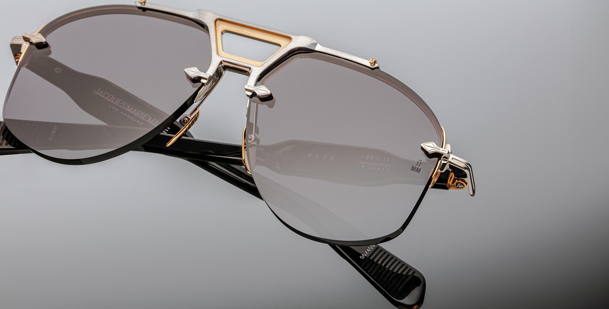 Close-up view of Jacques Marie Mage Alta sunglasses featuring a metal bridge and dark lenses.