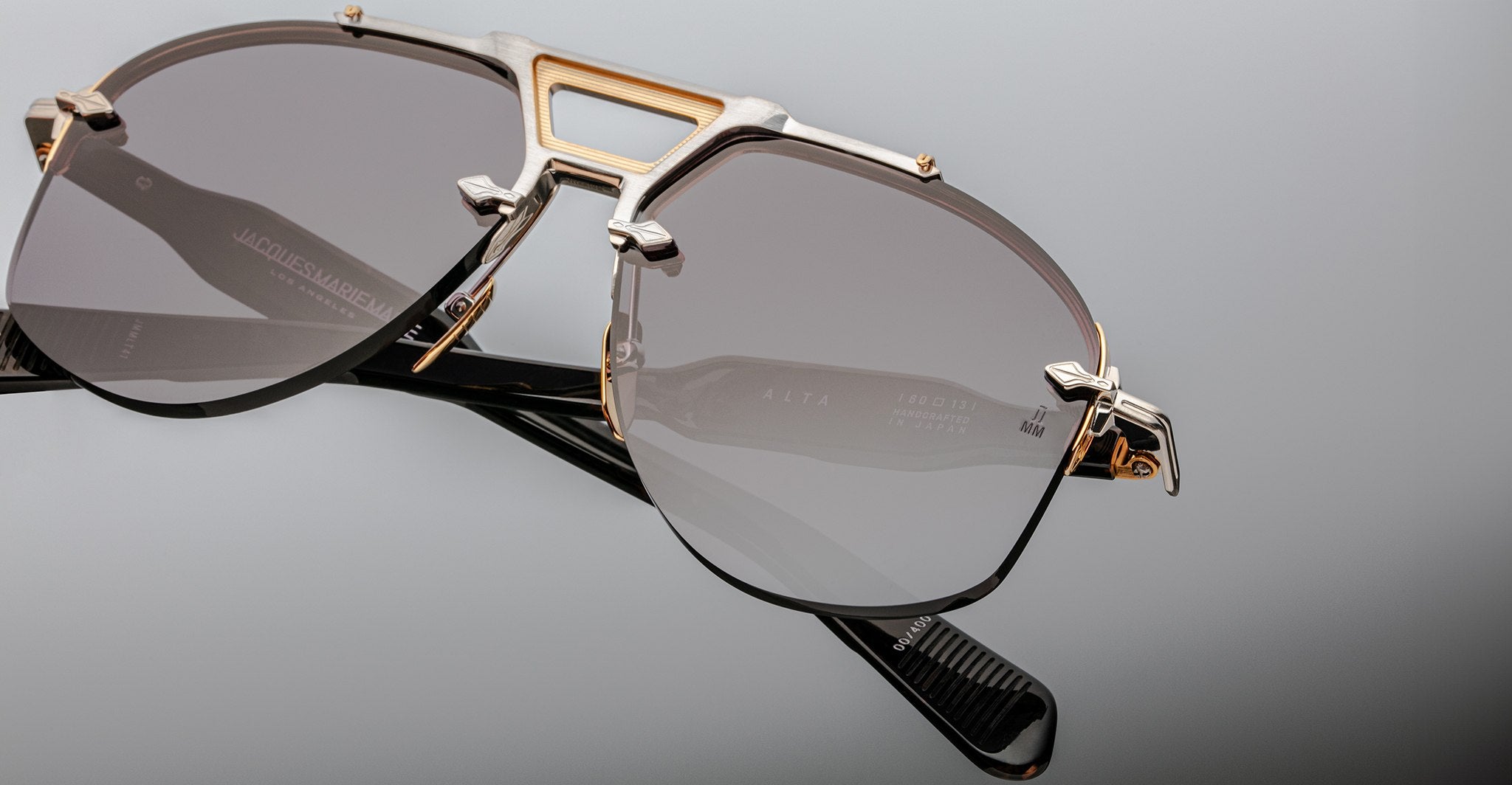 Close-up view of Jacques Marie Mage Alta sunglasses featuring a metal bridge and dark lenses.