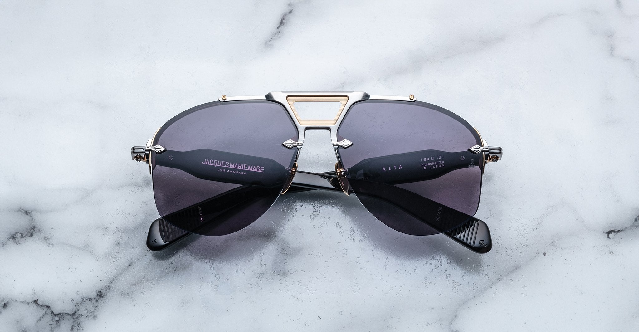 Jacques Marie Mage Alta black aviator sunglasses with gold accents, top view showing full frame and bridge details.