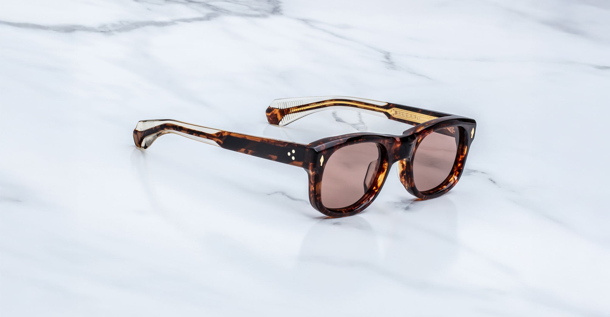 Jacques Marie Mage Amilcar sunglasses with tinted lenses shown from above.