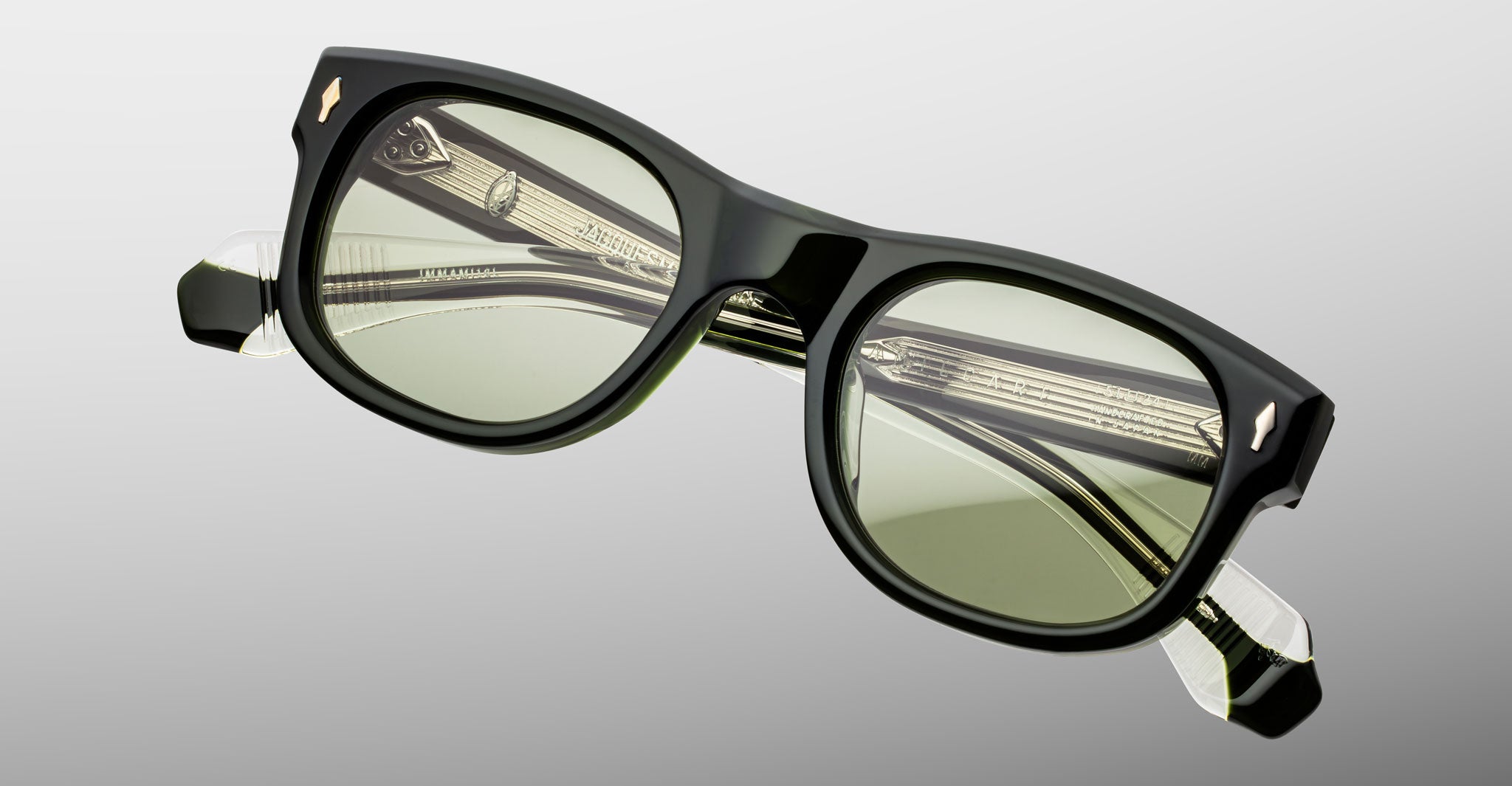 Jacques Marie Mage Amilcar black rectangular eyeglasses with green lenses, front view.