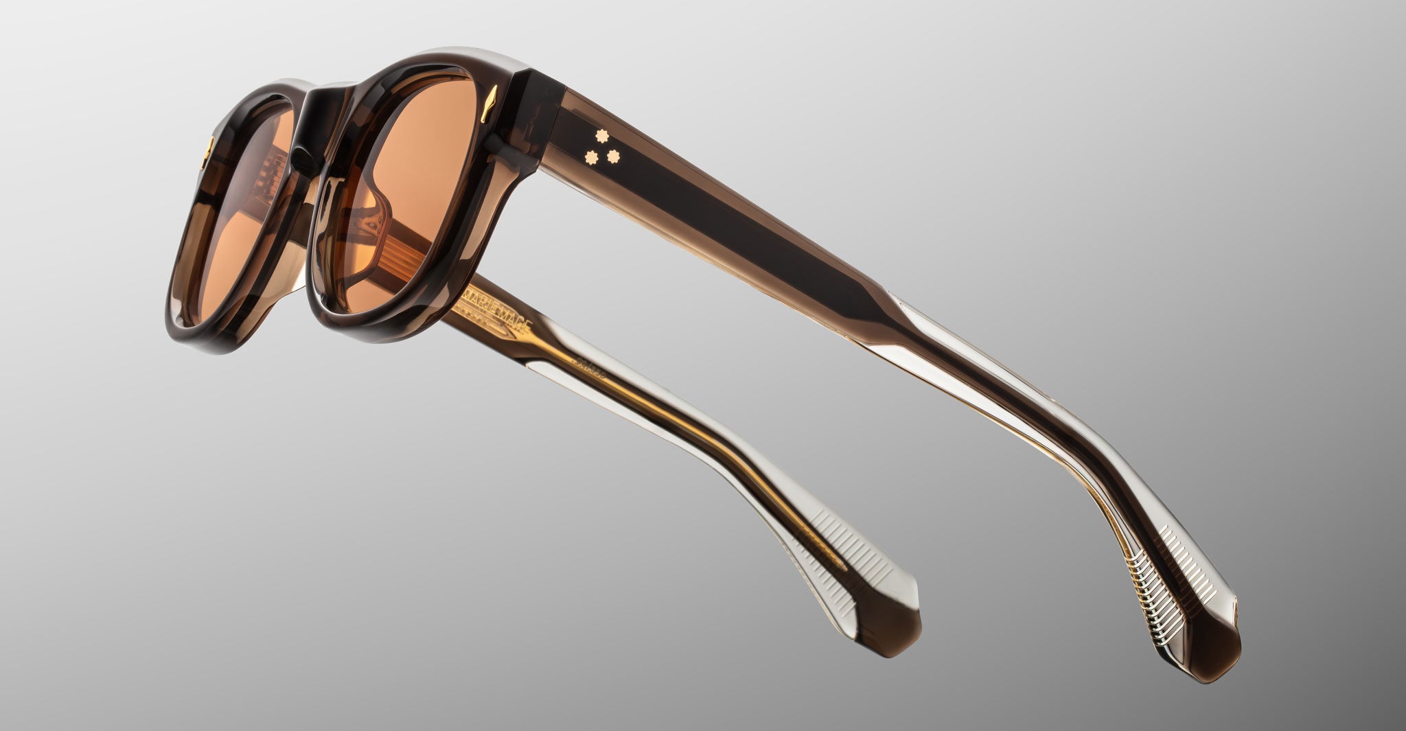 Jacques Marie Mage Amilcar sunglasses with thick brown frames and amber lenses, shown from the front.