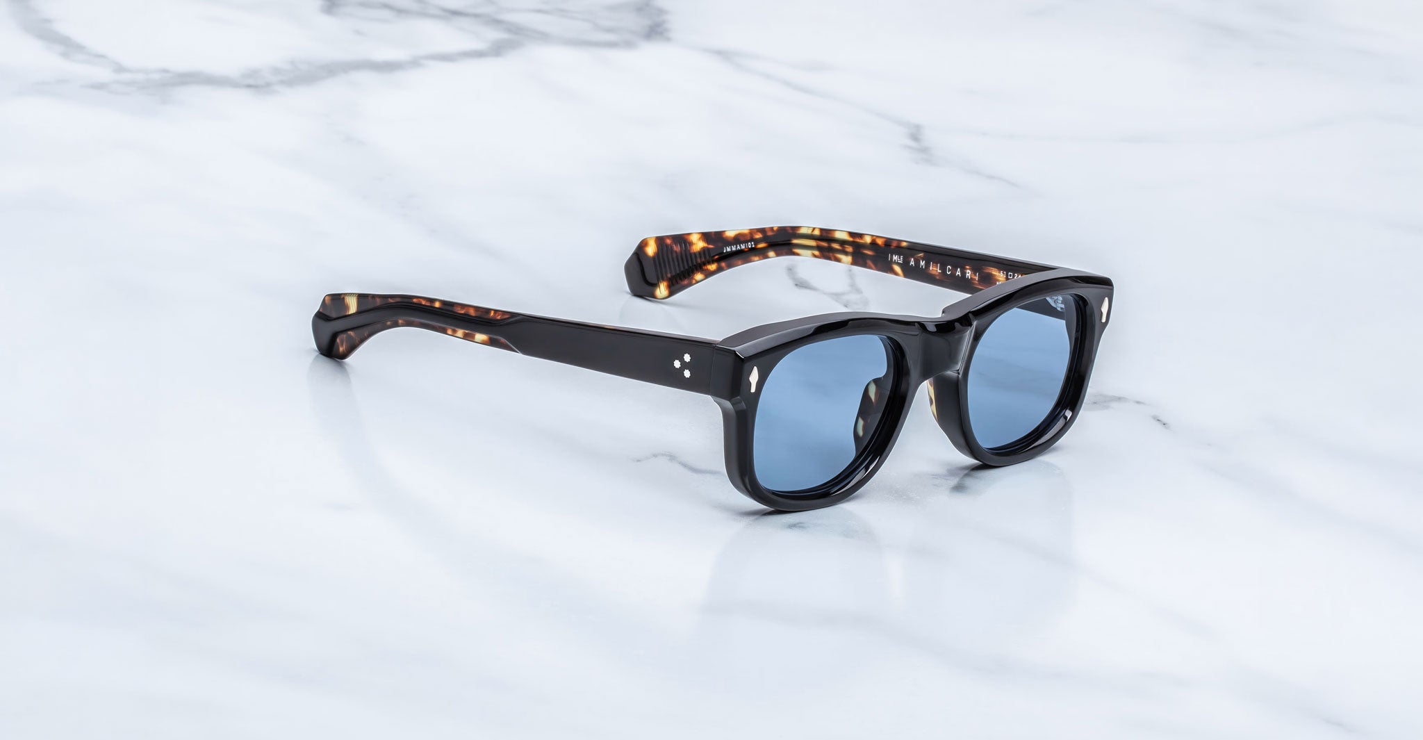 Jacques Marie Mage Amilcar sunglasses with blue polarized lenses and tortoiseshell arms, top front view.