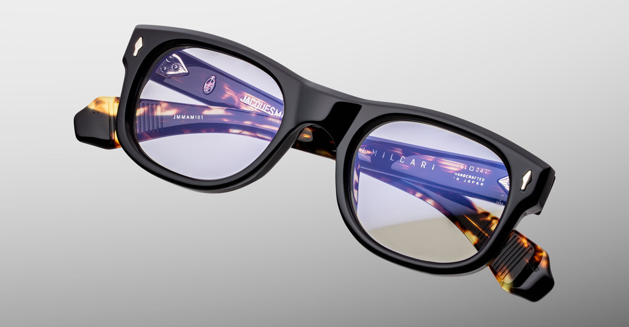 Jacques Marie Mage Amilcar eyeglasses, thick black and tortoiseshell frames, front view.