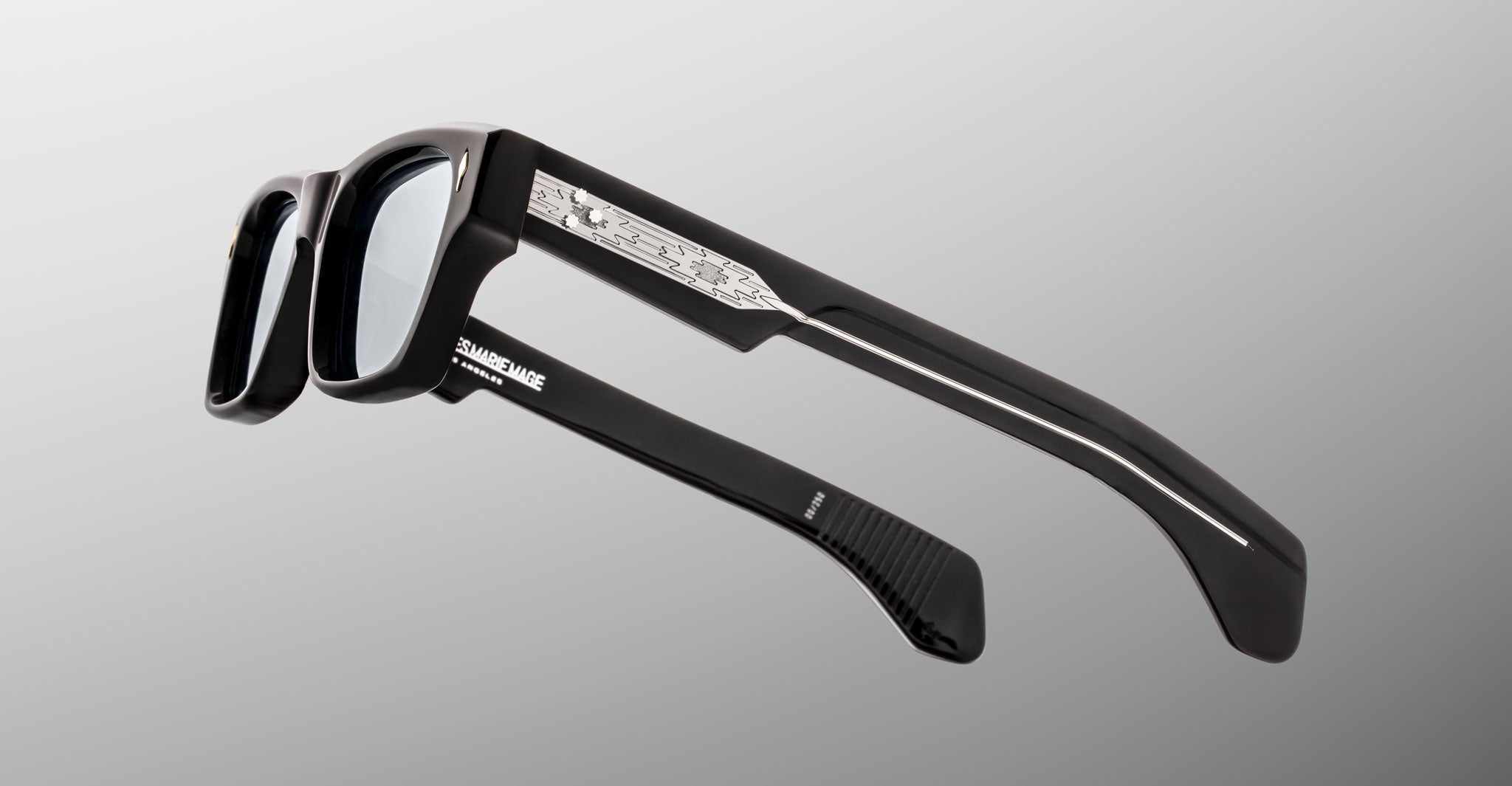 Jacques Marie Mage Ashcroft in Black Mirror acetate featuring a bold rectangular frame, exposed engraved wirecore temples, signature arrowhead front pins, and sculpted temple tips