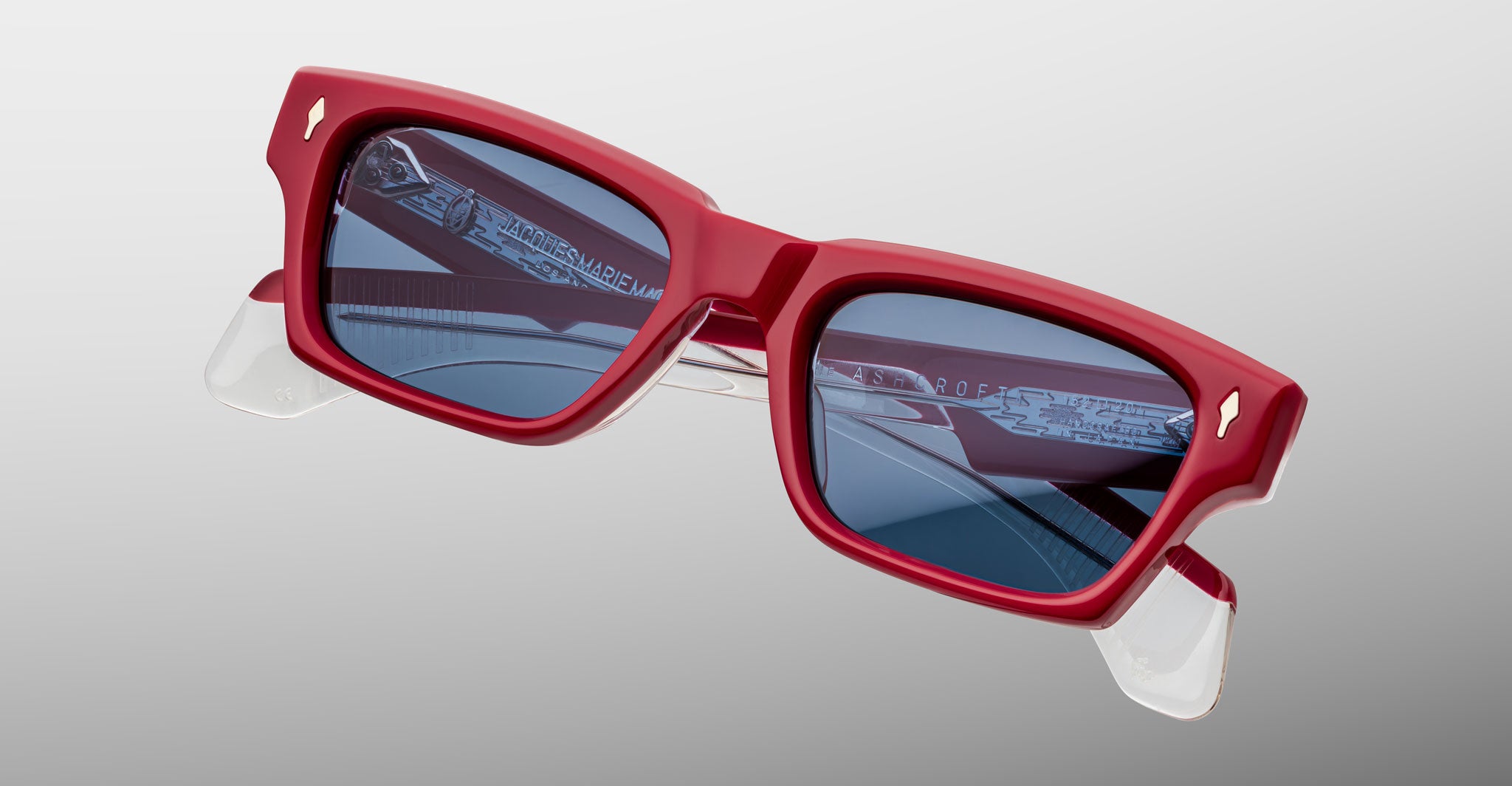 Jacques Marie Mage Ashcroft in Pirate acetate featuring a bold rectangular frame, signature arrowhead front pins, sculpted temples, and blue tinted lenses