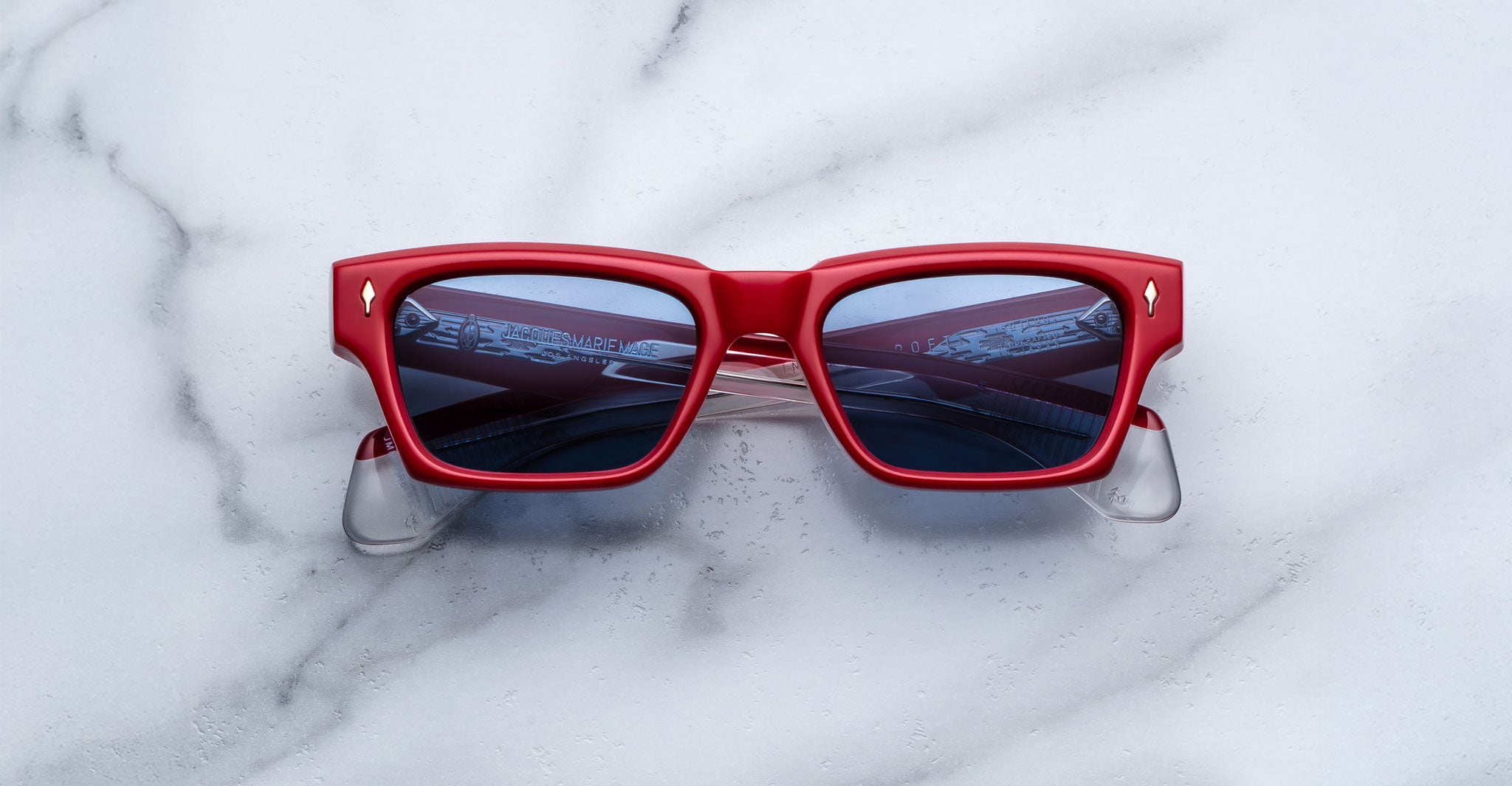 Jacques Marie Mage Ashcroft in Pirate acetate featuring a bold rectangular frame, signature arrowhead front pins, sculpted temples, and blue tinted lenses