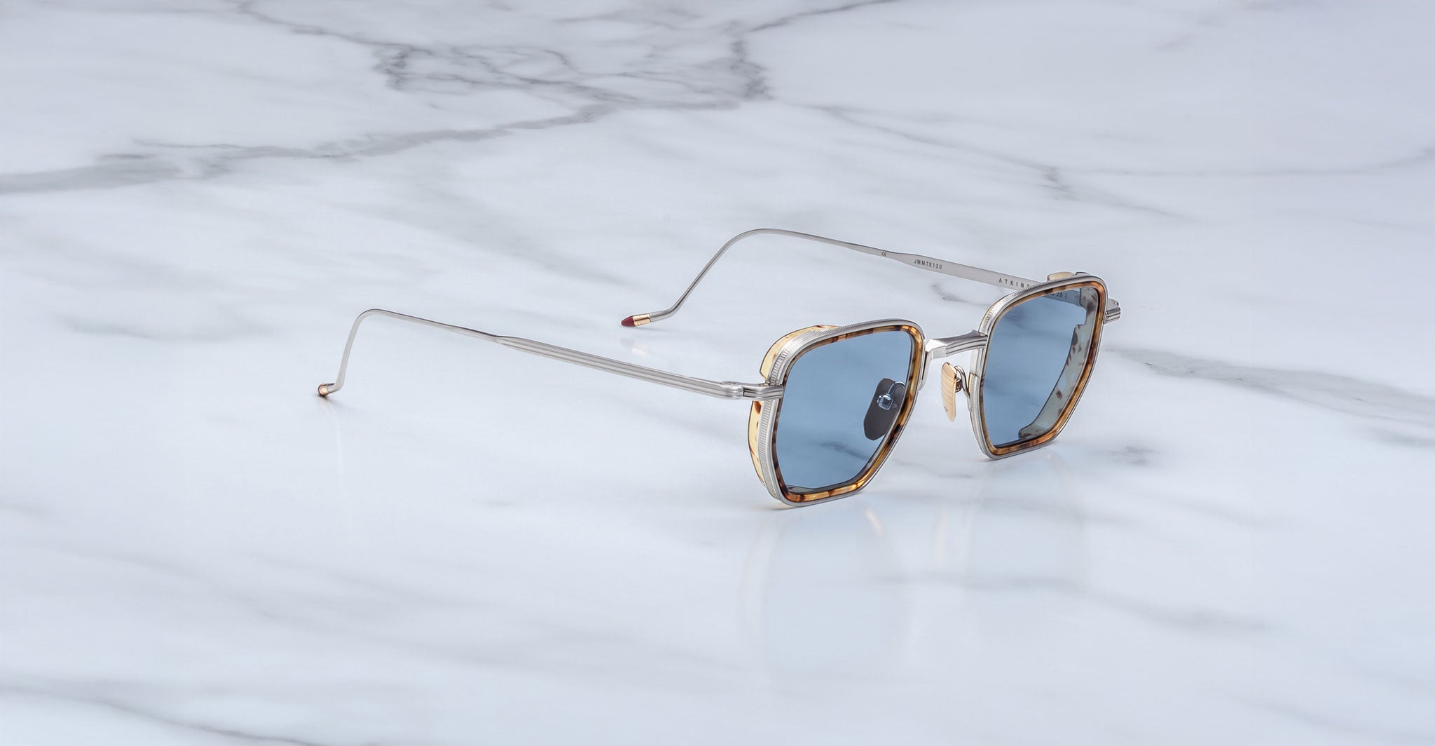 Jacques Marie Mage Atkins aviator sunglasses with blue lenses, viewed from above, showing full frame and lens color.