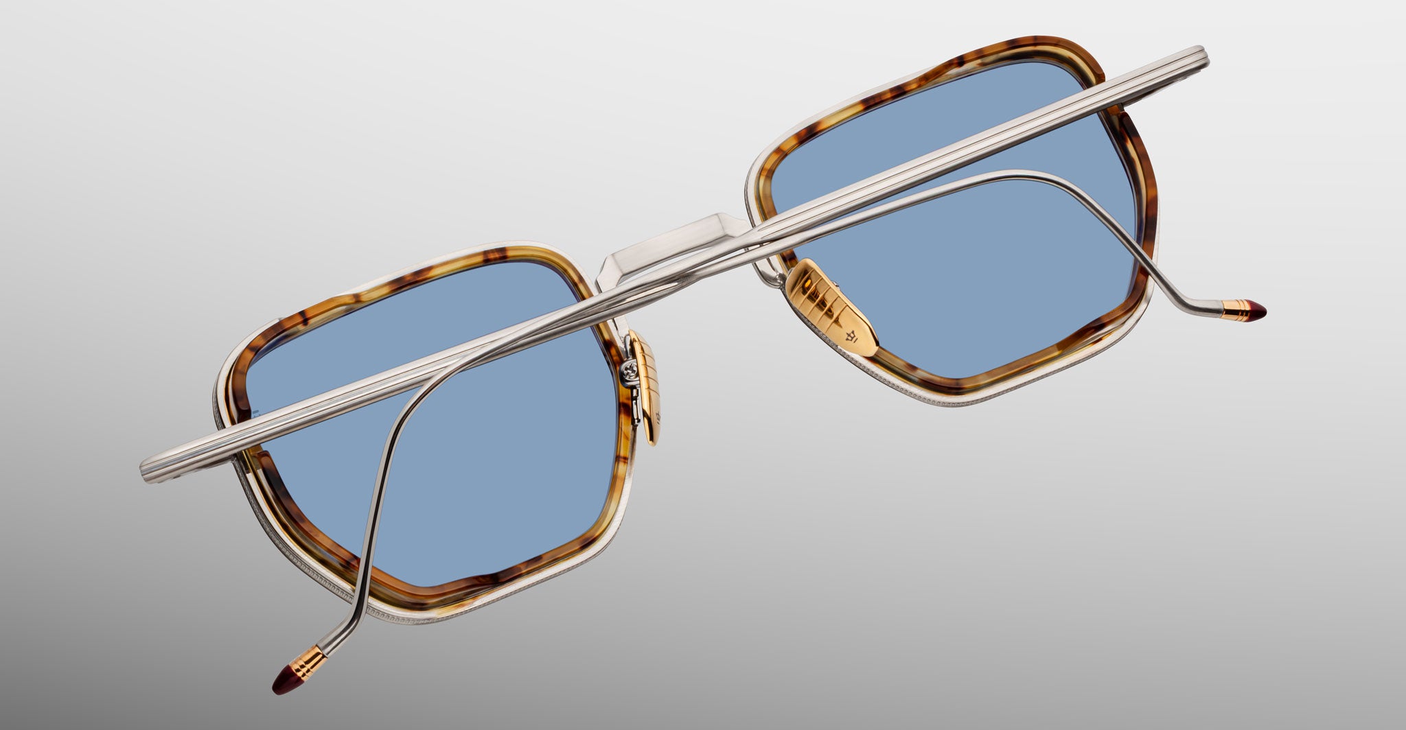 Jacques Marie Mage Atkins sunglasses with rectangular tortoiseshell frames, blue lenses, thin silver arms; overhead view.