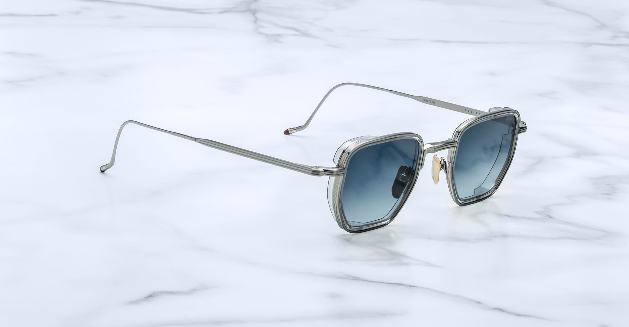 Jacques Marie Mage Atkins rectangular silver sunglasses with blue lenses, front view.