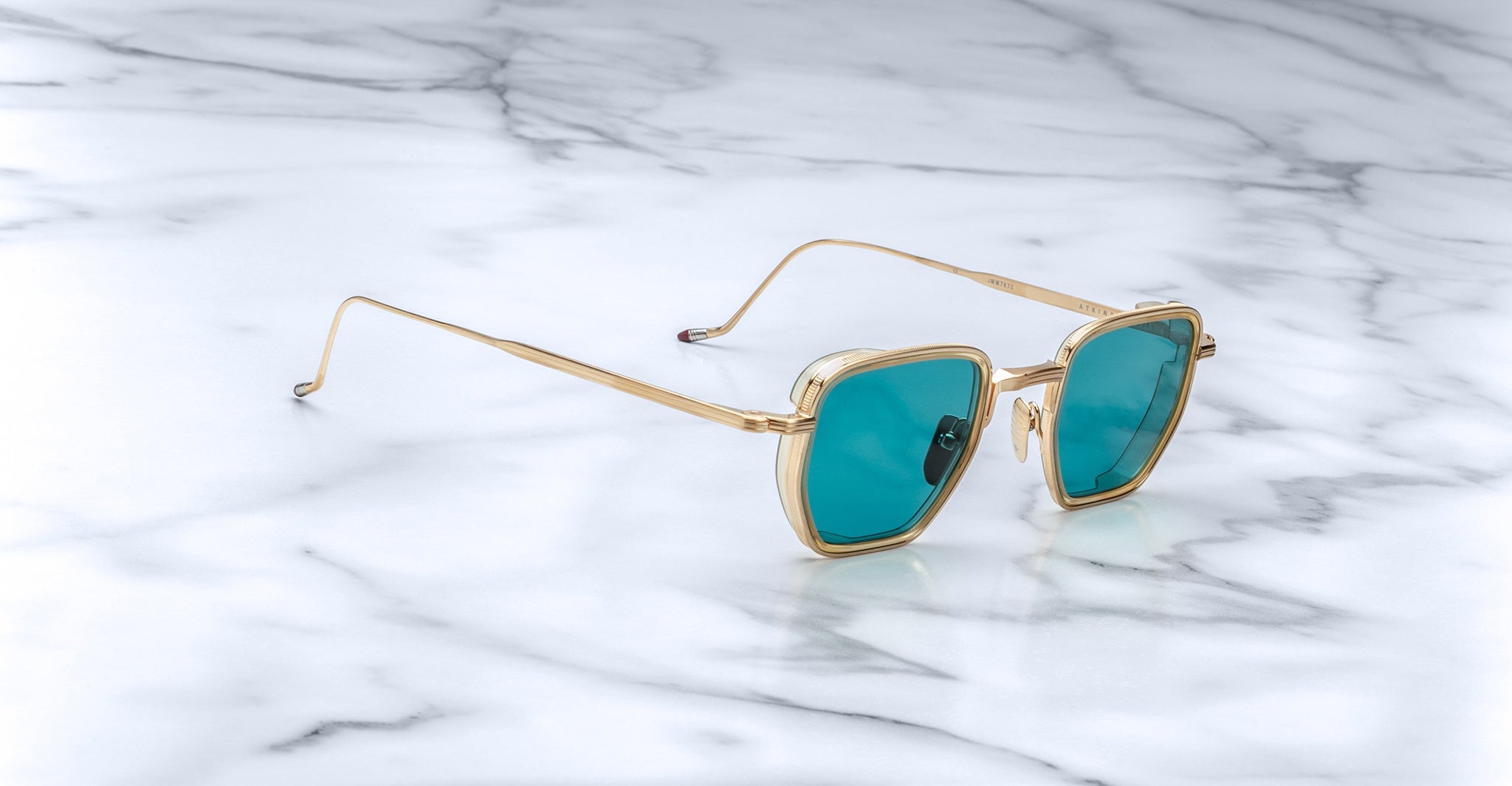 Jacques Marie Mage Atkins sunglasses, gold frames and blue lenses, top view.