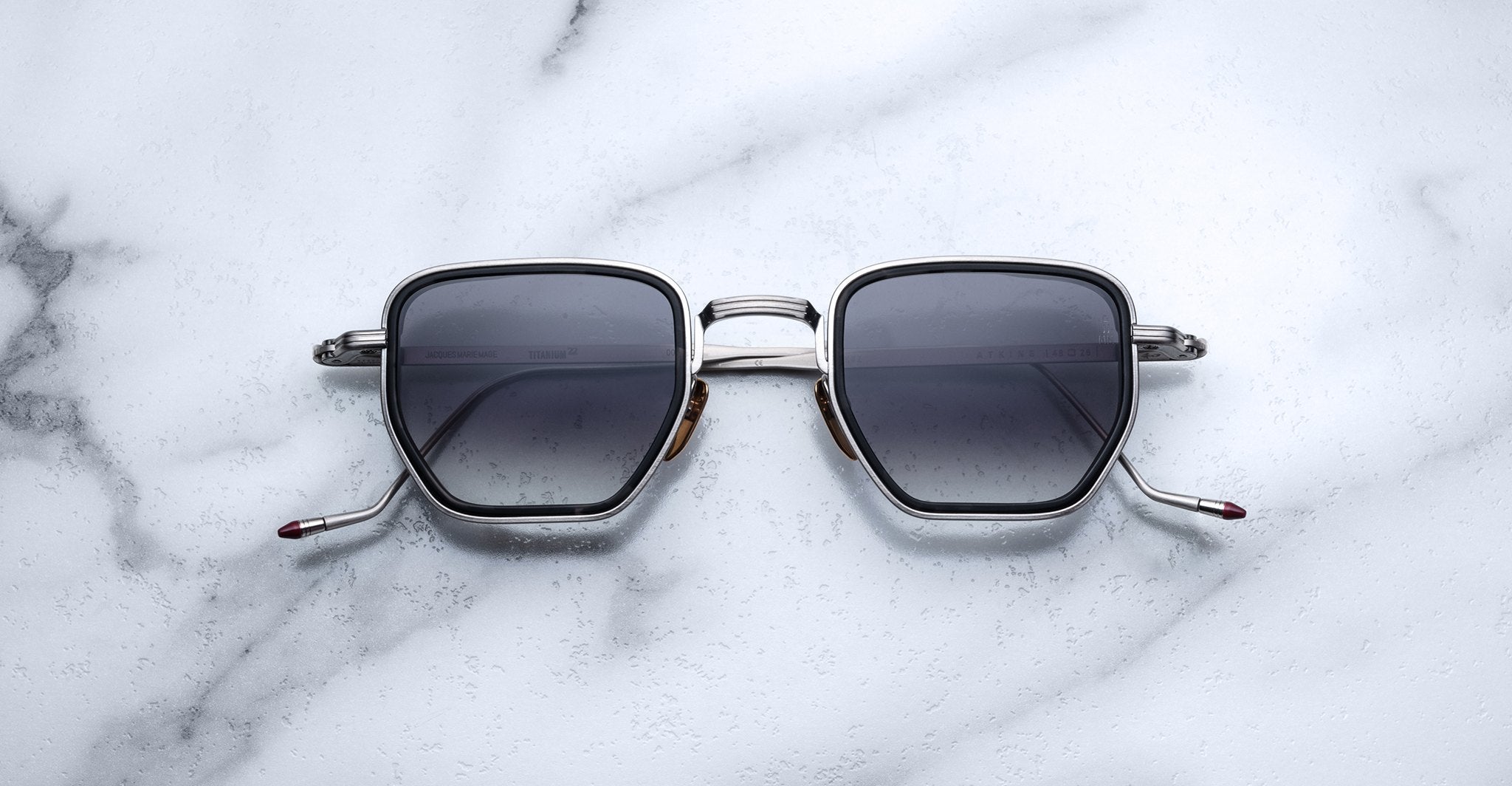 Jacques Marie Mage Atkins square sunglasses with dark lenses and silver frames, front view shown.