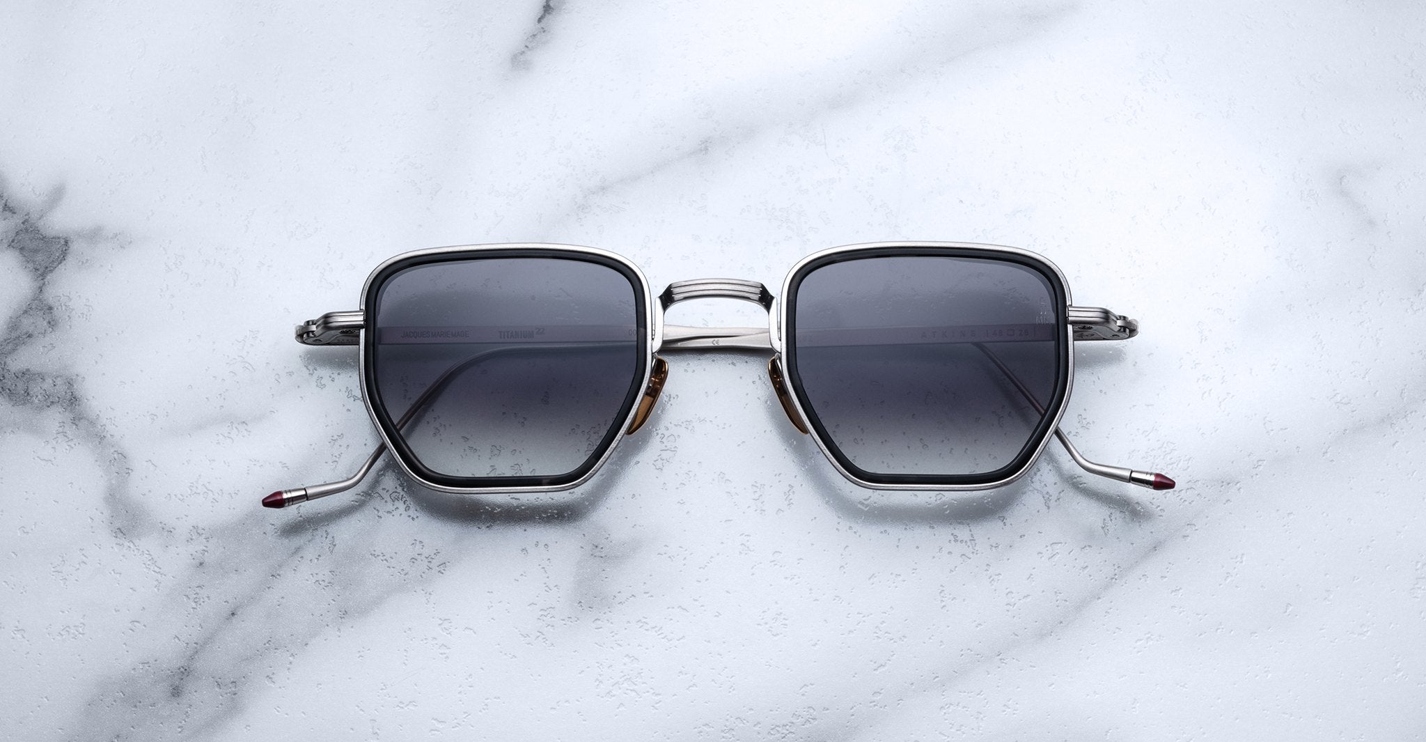 Jacques Marie Mage Atkins square sunglasses with dark lenses and silver frames, front view shown.