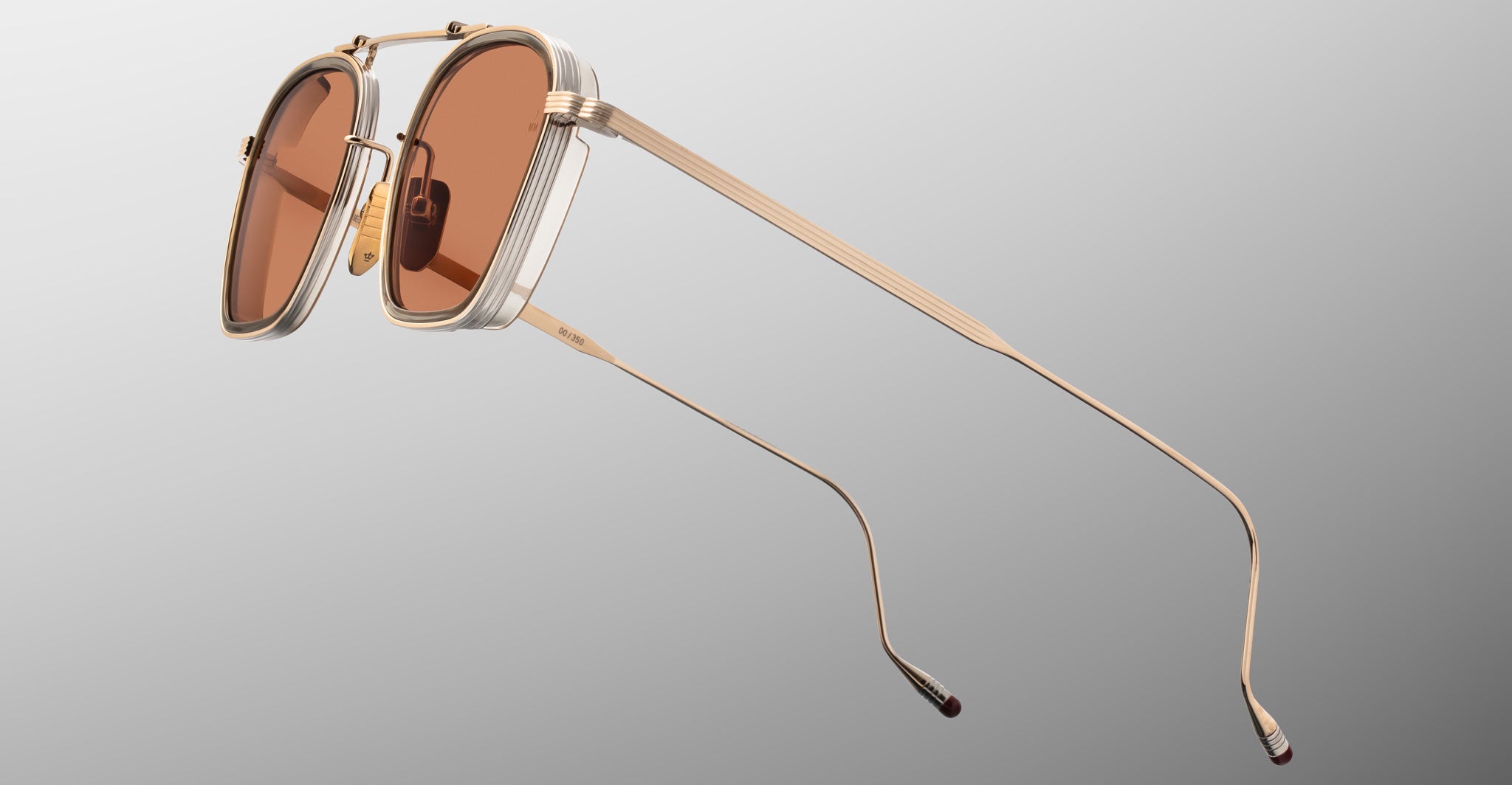 Jacques Marie Mage Baudelaire 2 sunglasses with gold frames and brown lenses, front view.
