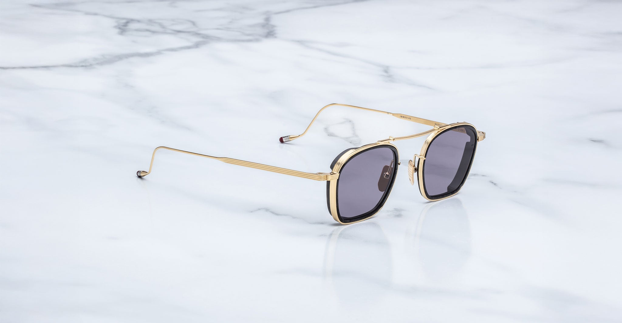 Jacques Marie Mage Baudelaire 2 aviator sunglasses with gold frames and dark lenses, front view.