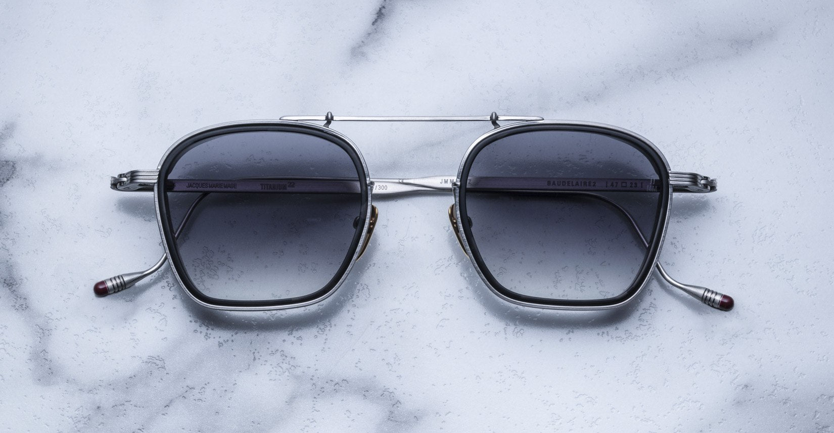 Jacques Marie Mage Baudelaire 2 silver sunglasses with UV protection, top view, showing metal frame and dark lenses.