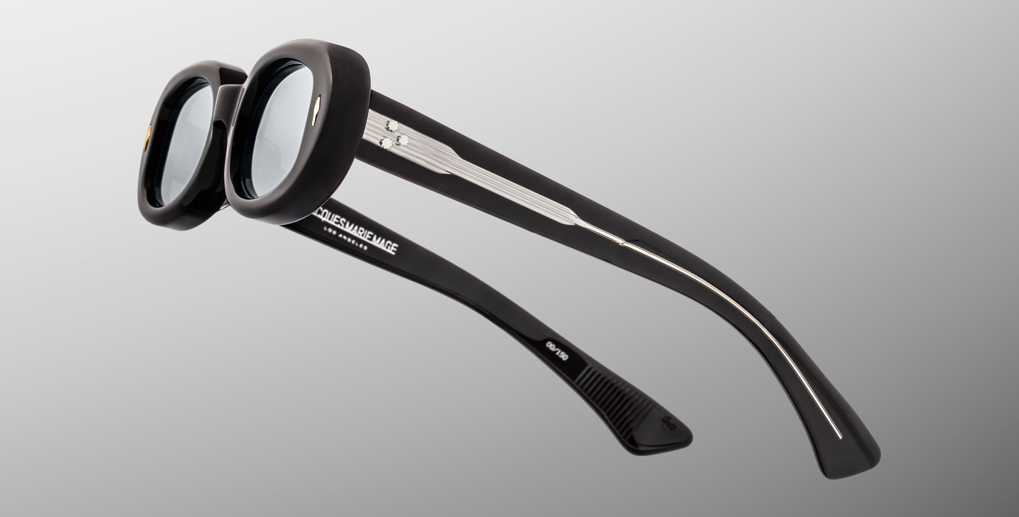 Jacques Marie Mage Besset sunglasses, black round thick frames, silver accents on arms, shown from the front angle.