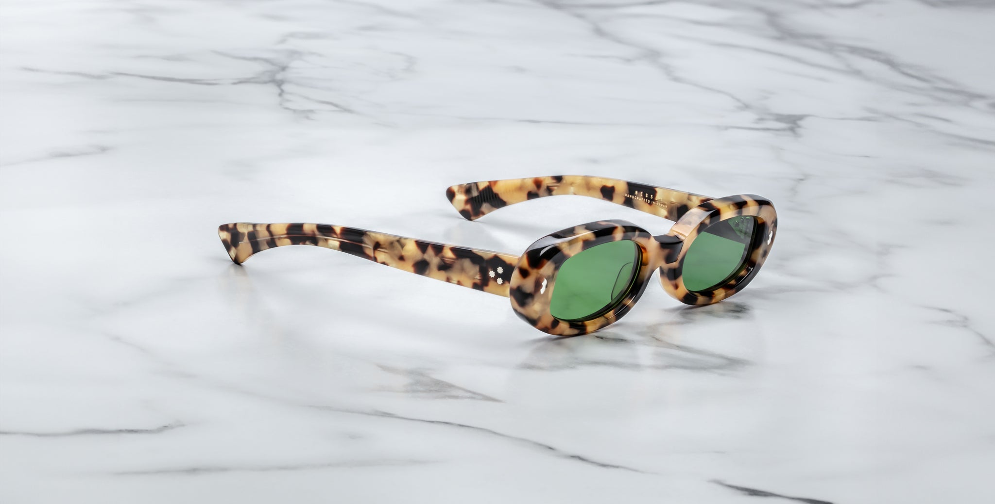 Jacques Marie Mage Besset cat-eye sunglasses in tortoiseshell with green lenses, top view.