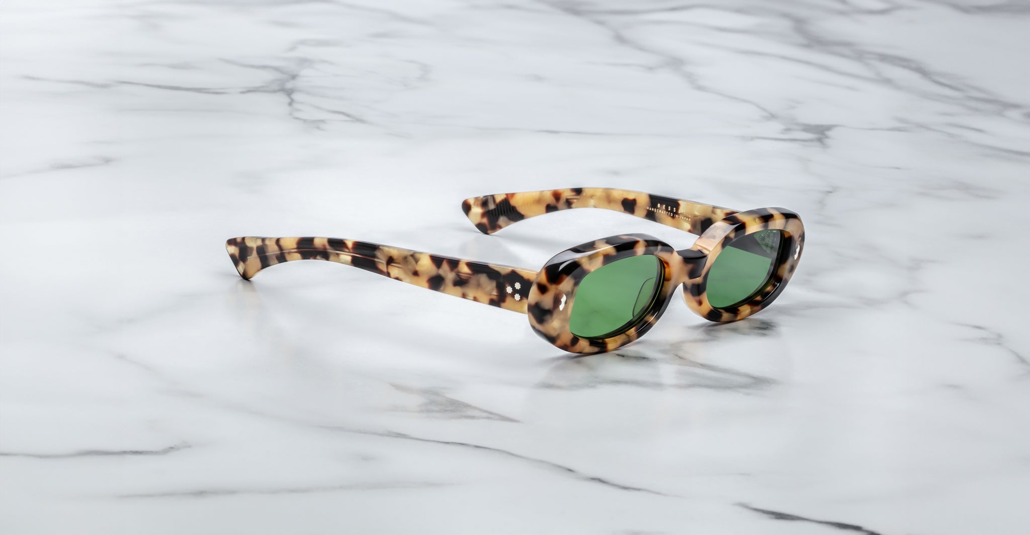 Jacques Marie Mage Besset cat-eye sunglasses in tortoiseshell with green lenses, top view.