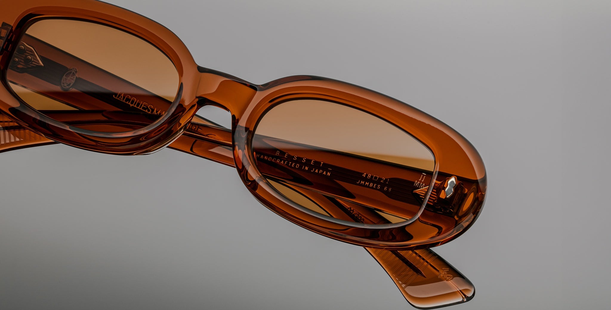 Jacques Marie Mage Besset brown acetate sunglasses, close-up angle showing engraved logo on the temple.