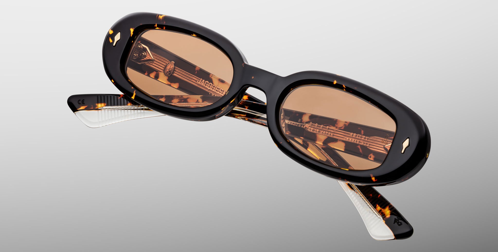 Jacques Marie Mage Besset sunglasses in brown and yellow tortoise shell pattern with orange lenses close-up front view