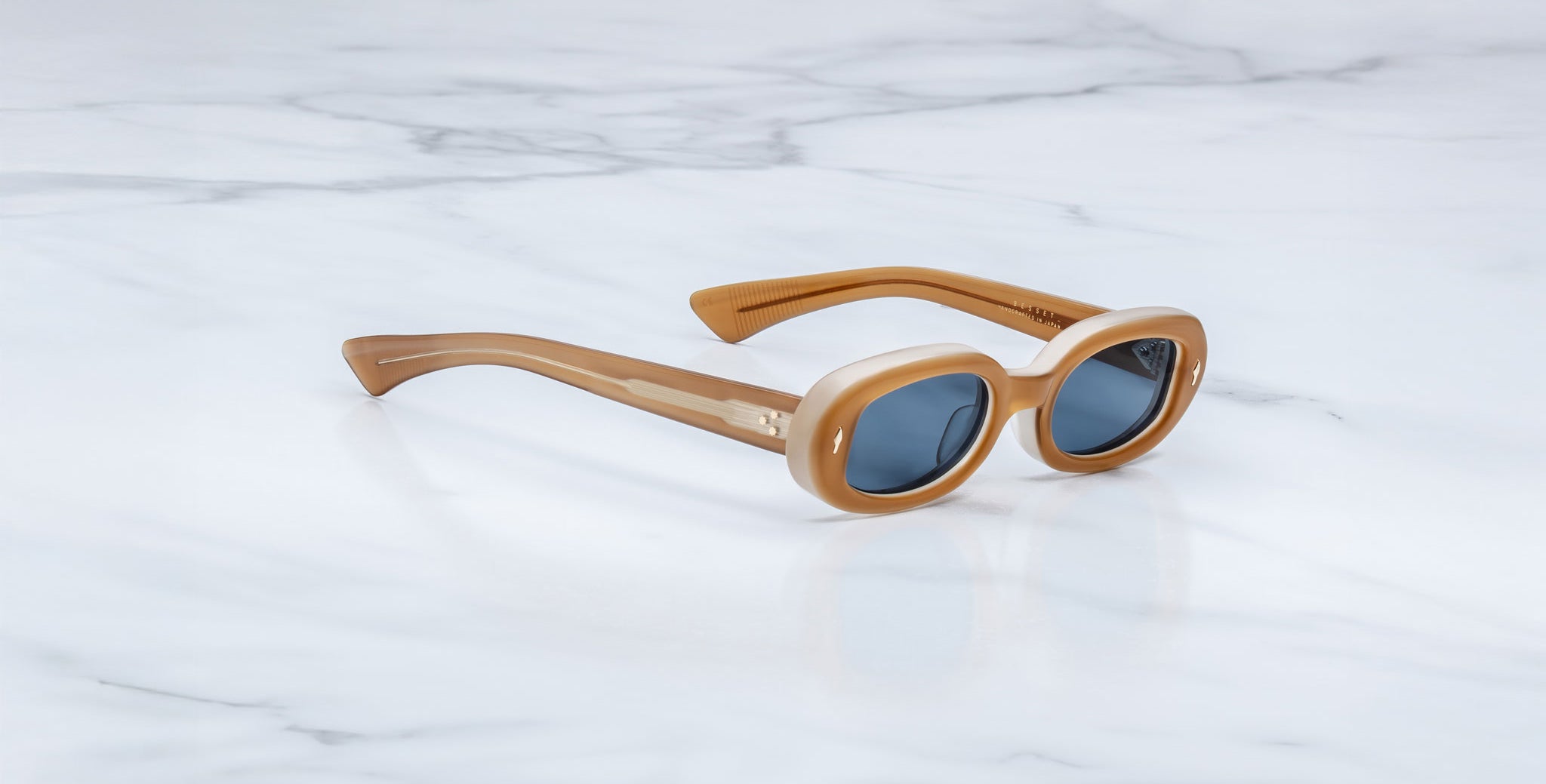 Jacques Marie Mage Besset sunglasses in tan with blue lenses shown at a front angle
