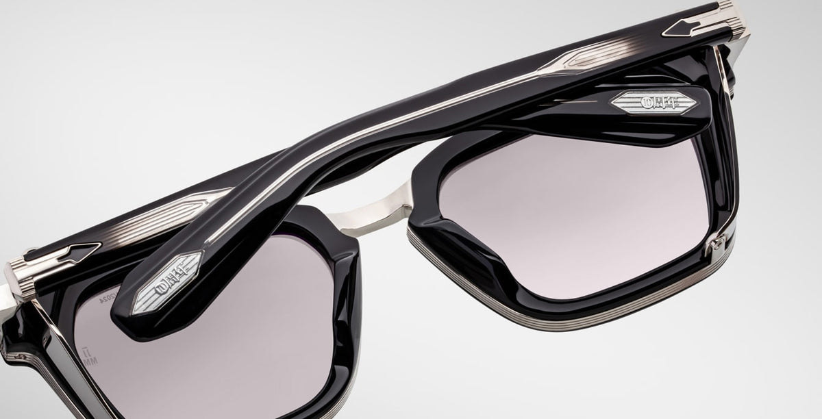 Close-up of Jacques Marie Mage Borodino rectangular sunglasses in black and silver with tinted lenses and prominent metal accents.