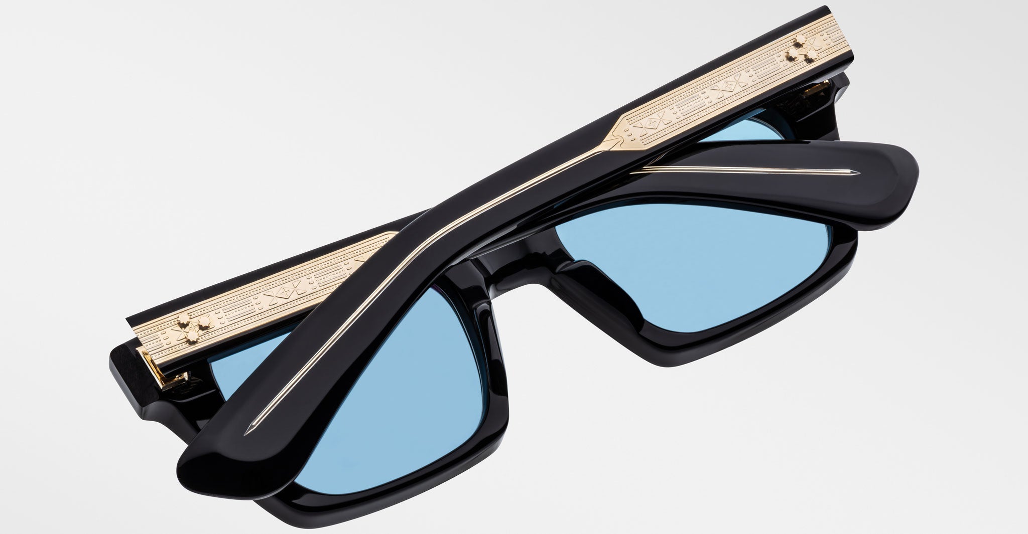 Jacques Marie Mage Quentin sunglasses, blue polarized lenses, gold details, folded frame shown from above.